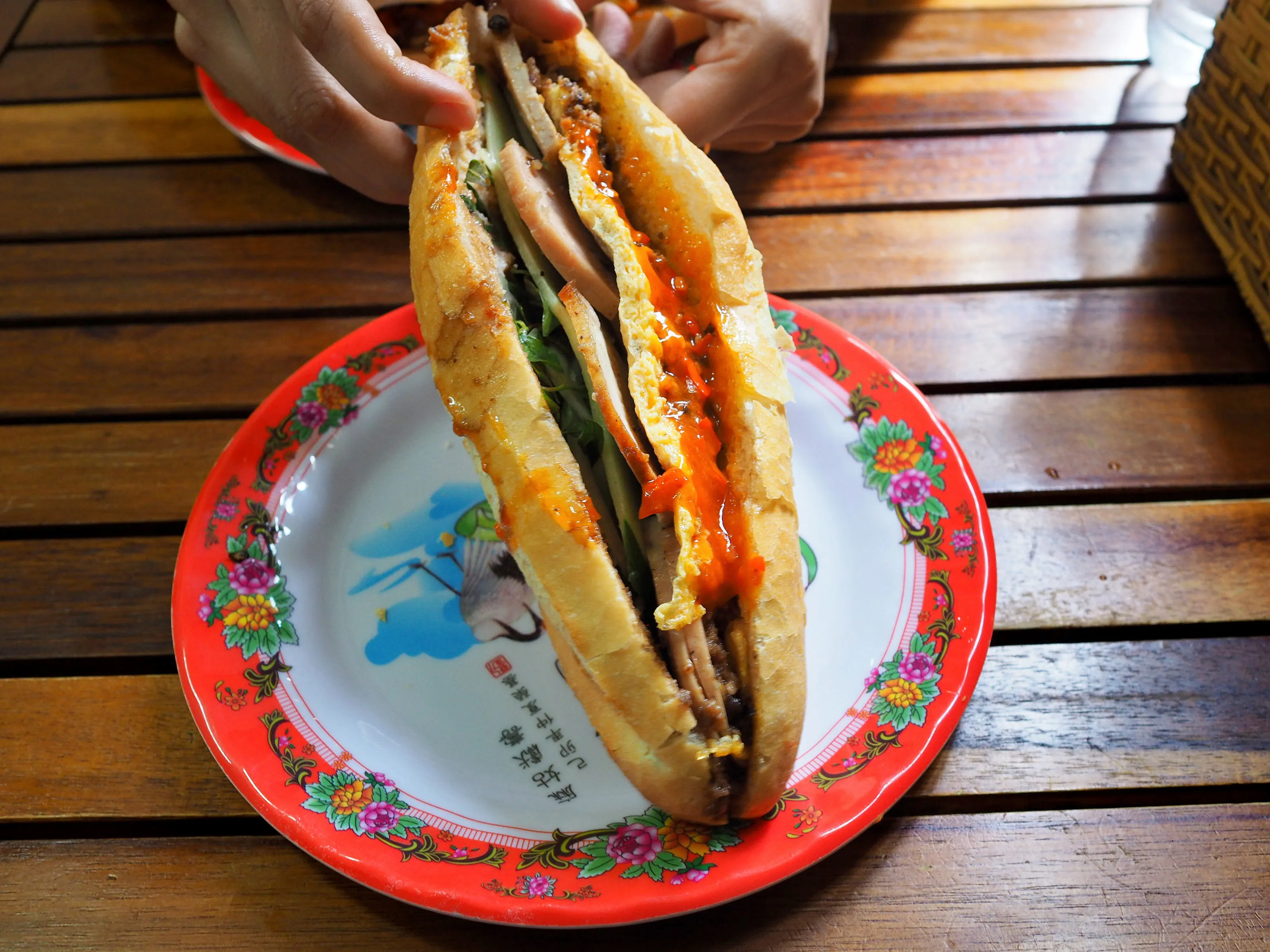 Banh mi is a heavenly combination of crispy, fluffy baguette, egg, a flavourful protein, fresh herbs, cucumbers and radishes, spicy chilli, pork liver pâté and an umami rich sauce.